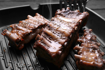 Grill pan with tasty ribs, closeup