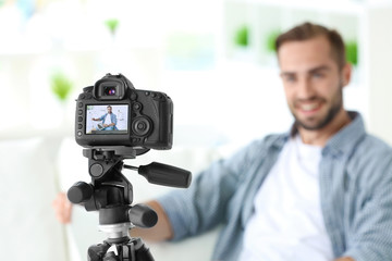 Young blogger recording video at home