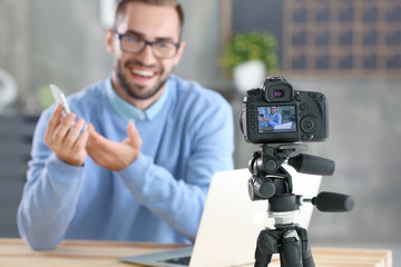 Young blogger recording video at home