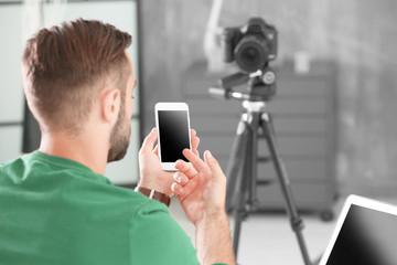 Young blogger recording video at home