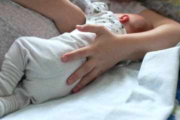 Mother breastfeeding her baby. Back of baby boy