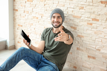 Young blogger with tablet at home