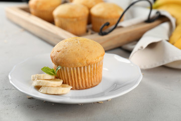 Plate with banana muffin on table