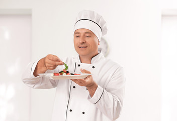 Male chef making salad in kitchen