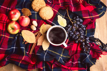 Cup of coffee Apple Cookies Cinnamon Grape Wooden background Autumn blanket Autumn lifestyle concept Top view