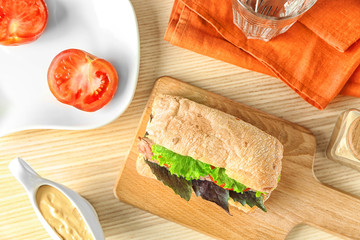 Composition with delicious steak sandwich on table