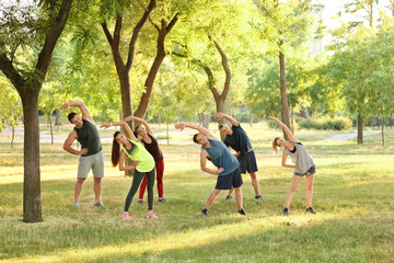 Group of young people stretching outdoors