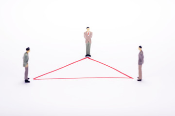 Fototapeta premium Miniature business people in conection scheme over white backdrop or background.