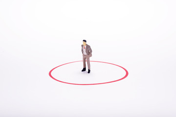 Fototapeta premium Miniature people, business man in red circle over white backdrop or background.