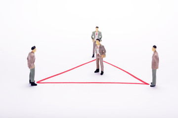 Miniature business people in conection scheme over white backdrop or background.