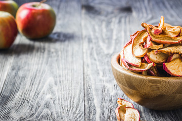 Candied apple slices on wooden background. Selective focus, space for text, toned.
