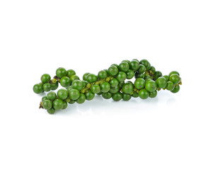 green peppercorns on white background