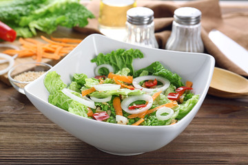 Delicious vegetable salad on table