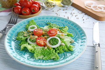 Delicious vegetable salad on table