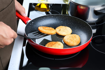 Man cooking pancakes on frying pan