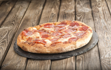 pizza pepperoni on wooden table close up