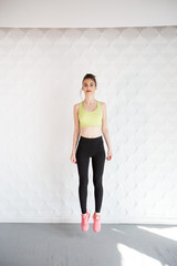 Girl in a yellow swimsuit in the gym teaches yoga for a healthy life. Exercise for every day