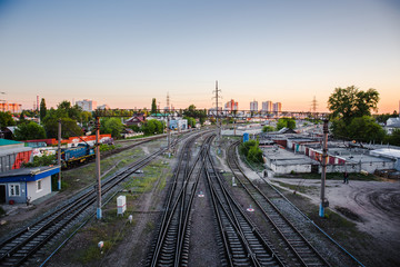 Fototapeta na wymiar Railroad at sunset. Railway station, Industrial logistic and transportation concept background
