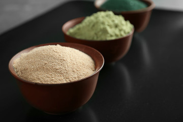 Superfood powder in bowl on table, closeup