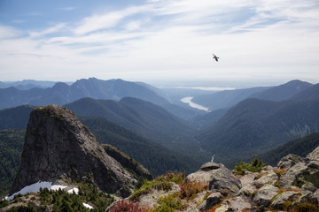 Beautiful landscape view of mountain top, valley, and Capilano Lake. Picture taken at the top of...