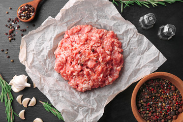 Parchment paper with fresh minced meat on table