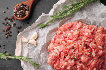 Parchment paper with fresh minced meat on table