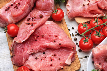 Different types of raw meat on wooden table