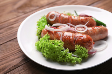 Grilled sausages served with vegetables on white plate