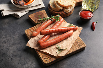 Composition with grilled sausages on kitchen table