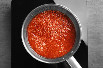Saucepan with brown rice on stove