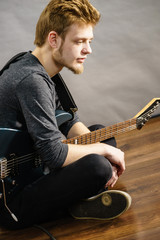 Obraz premium Young man playing electric guitar
