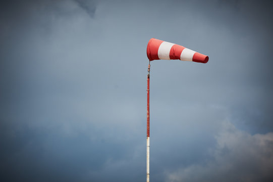 Windsock blown by the wind with overcast sky