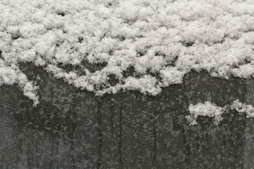 Melting snow on metal surface.