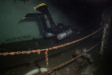 Underwater picture of a scuba diver exploring a sunken wreck ship. Taken in Howe Sound, near...