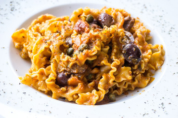 Spaghetti with aubergine and tomato sauce on a the table
