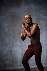 
African American dancing breakdance at a health sports center. Man teaches fitness exercises in the gym