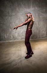 
African American dancing breakdance at a health sports center. Man teaches fitness exercises in the gym