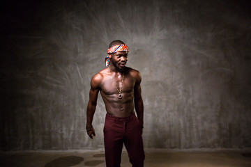 
African American dancing breakdance at a health sports center. Man teaches fitness exercises in the gym
