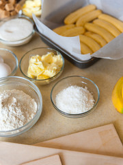 Cooking process on kitchen. Ingredients for sweet fruit dessert on table. Making of banana pie in home.