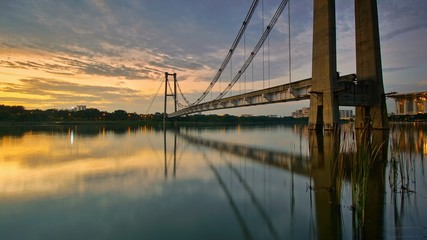 Beautiful modern bridge with nice reflection during sunset in Putrajaya Malaysia. Soft focus due to long exposure shot.