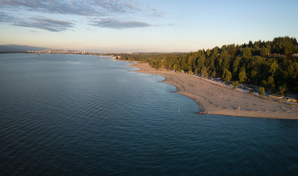 Aerial panoramic view of the beautiful beach, Spanish Banks, during a vibrant summer sunset. Taken in Vancouver, British Columbia, Canada.
