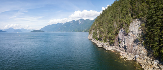 Aerial panorama of a rocky coast during a vibrant sunny summer day. Taken in Horseshoe Bay, West Vancouver, British Columbia, Canada.
