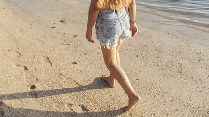 Young Woman Walking on The Beach 