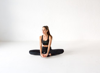 Fly yoga in a white gym. Gymnastics performs physical exercises fly-yogative