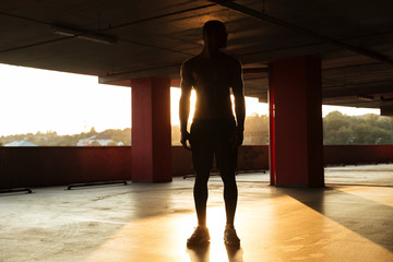 Full length portrait of a half naked afro american sportsman