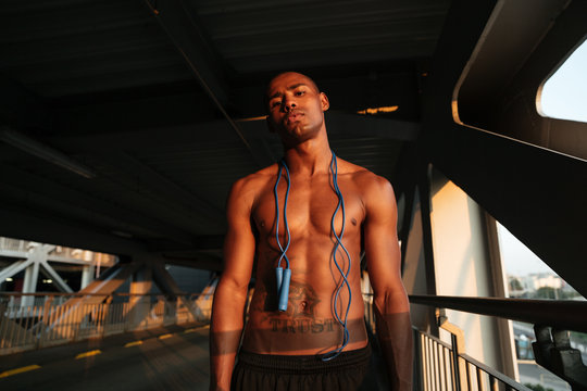 Portrait of a tired sweaty half naked african sportsman