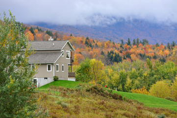 Vermont Fall Foliage in a cloudy day, Mount Mansfield in the background, Vermont, USA.