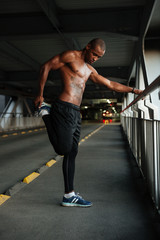 Fototapeta na wymiar Full length portrait of a motivated half naked african sportsman