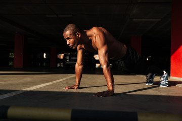 Fototapeta na wymiar Portrait of a half naked muscular afro american sportsman