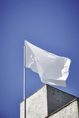 White flag blowing to the wind